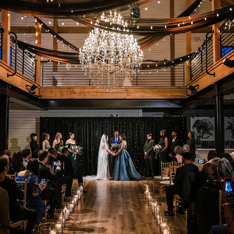 Brides stand before their officiant during the wedding ceremony.