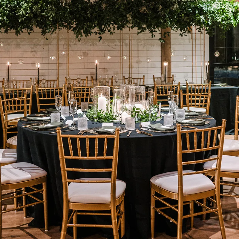 Table set with place cards, cocktail and champagne glasses, and flowers for guests. Brentsville Hall's Team can help you select the place settings or you can bring in whatever you'd like.