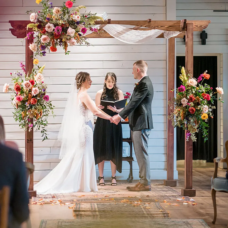 Bride and groom before the officiant during their wedding ceremony at Brentsville Hall in Manassas, VA.