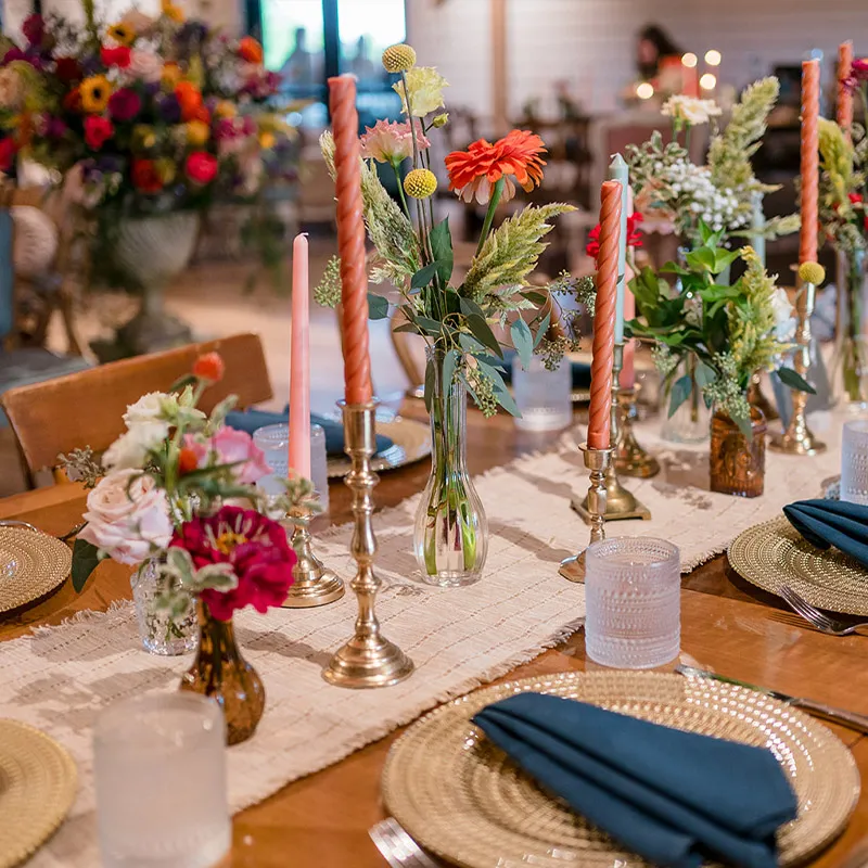 Table set for the reception with candles and cut flowers at Brentsville Hall in Northern Virginia
