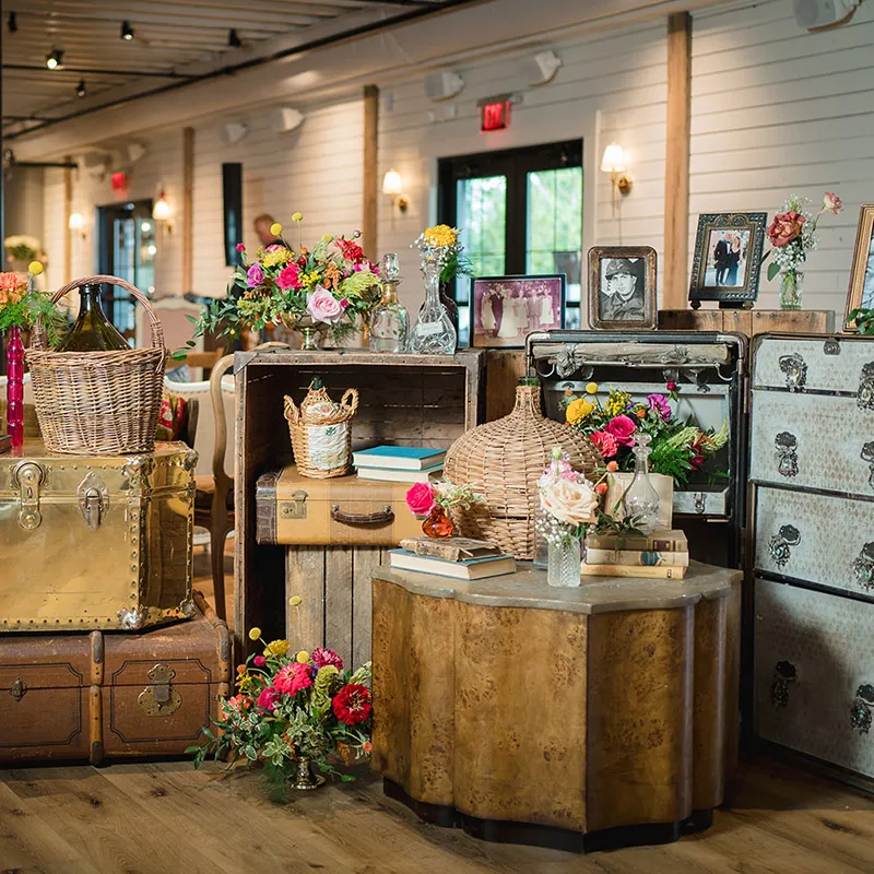 Family treasures on display amongst layers of flowers at the entry to the reception area