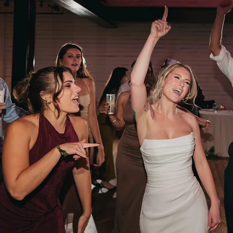 Bride and friends have fun singing along with the band at the reception