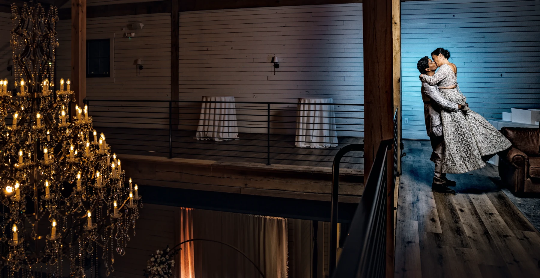 Bride and groom sneak off for a kiss in the upstairs mezzanine