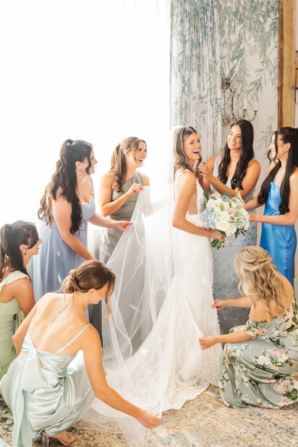 A bride prepares to walk down the aisle surrounded by bridesmaids straightening her dress